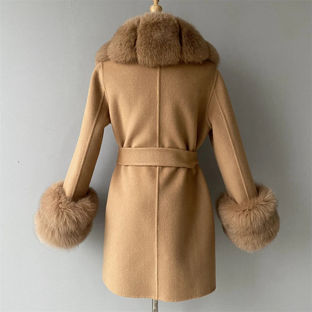 Beige coat with fur trim on a mannequin against a gray background