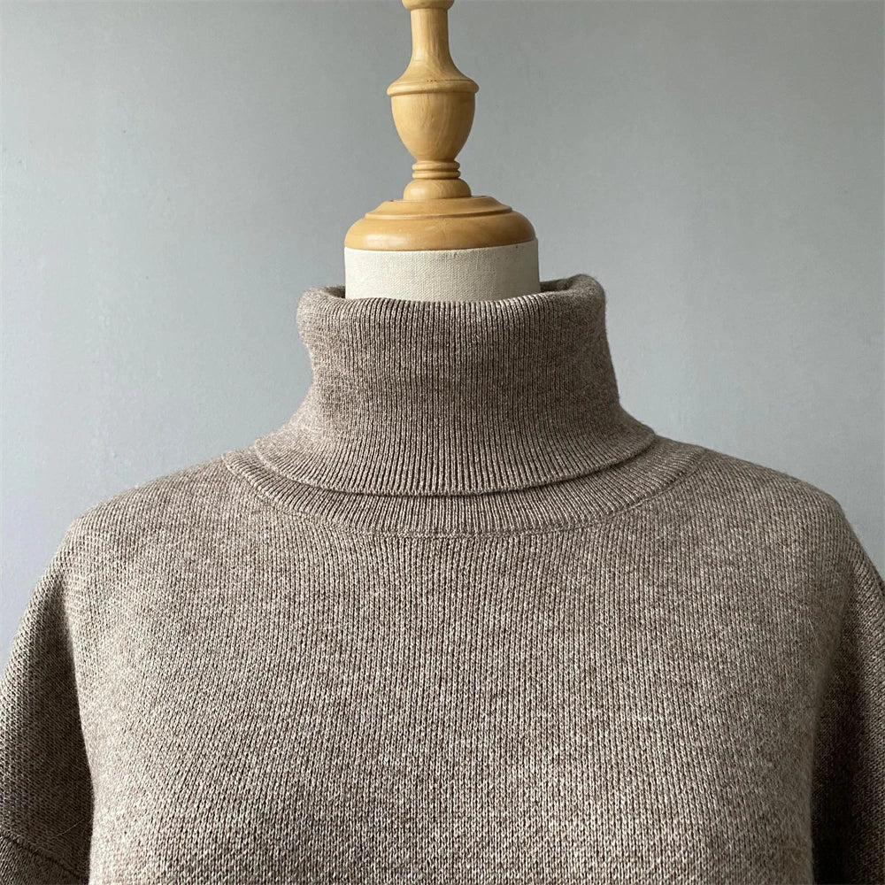 Brown turtleneck sweater on a mannequin against a gray background