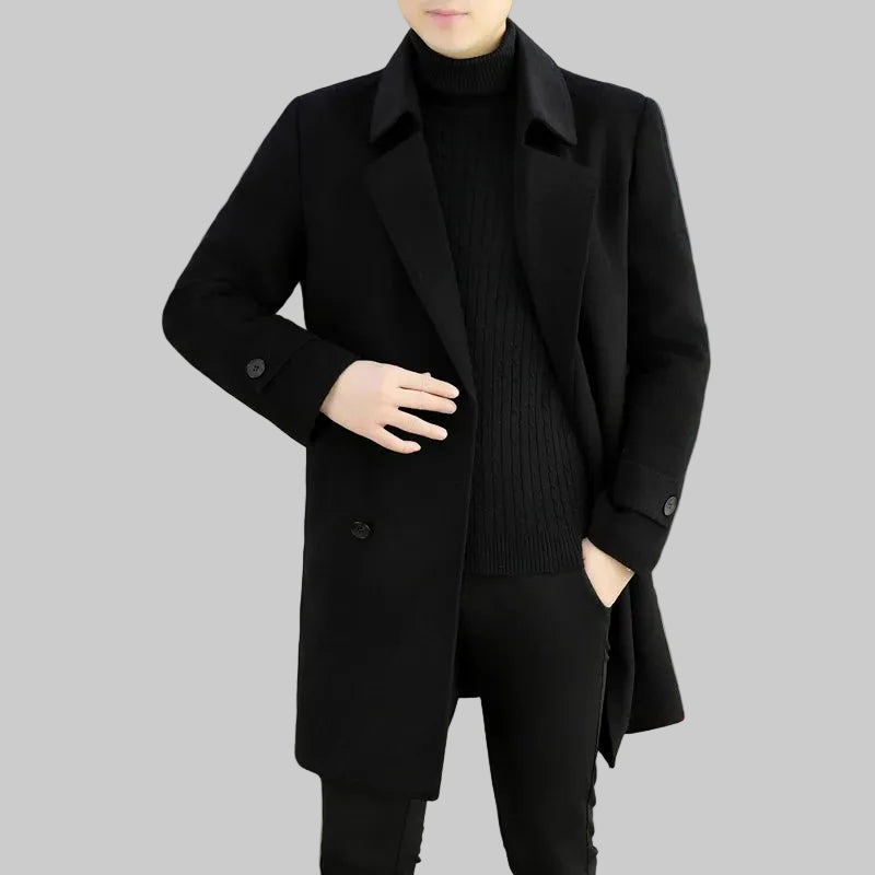 Person wearing a black coat in a room with a white couch.