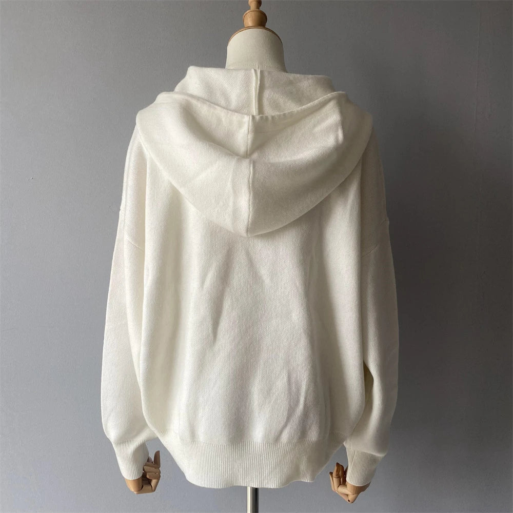 White hoodie on a mannequin against a gray background