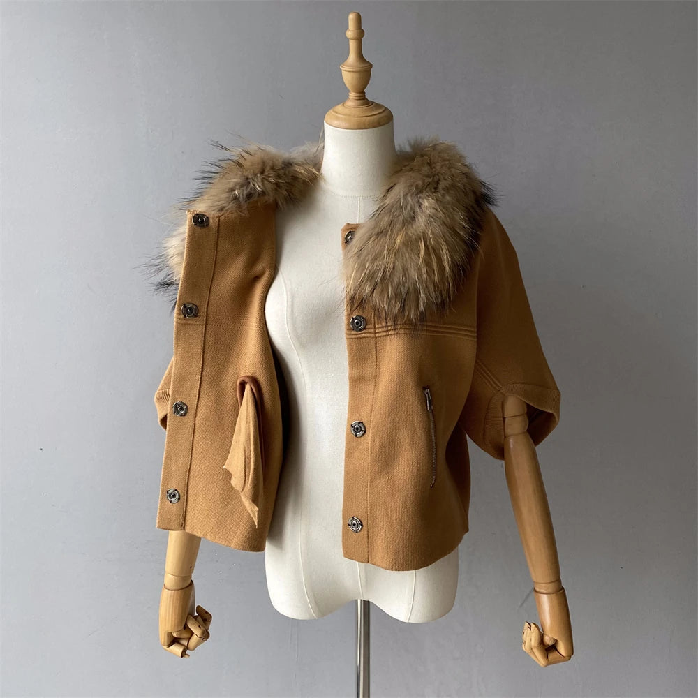 Brown jacket with fur hood on a mannequin against a gray background