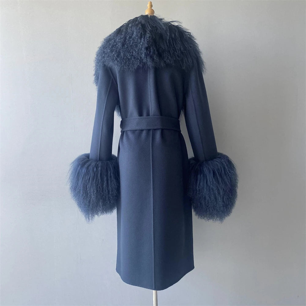 Blue coat with feathered cuffs and collar on a mannequin against a plain background