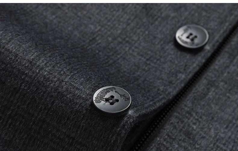 Close-up of a dark gray textured fabric with buttons, featuring a brand logo.