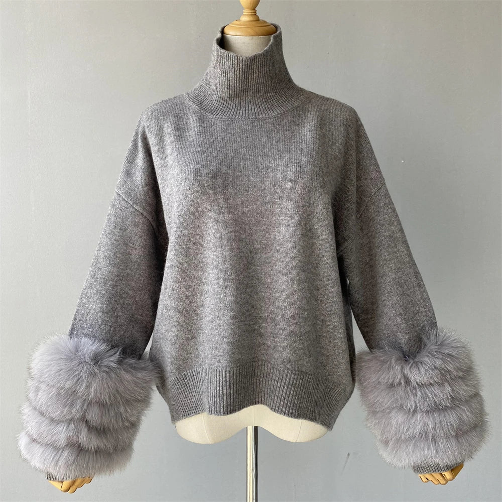Gray sweater with fur cuffs on a mannequin against a plain background