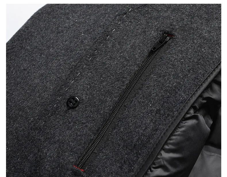 Close-up of a gray coat with a zipper and button detail on a white background