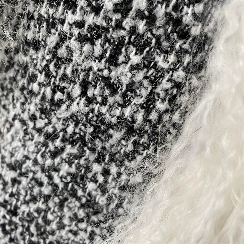 Close-up of textured fabric with a pattern of black and white threads.