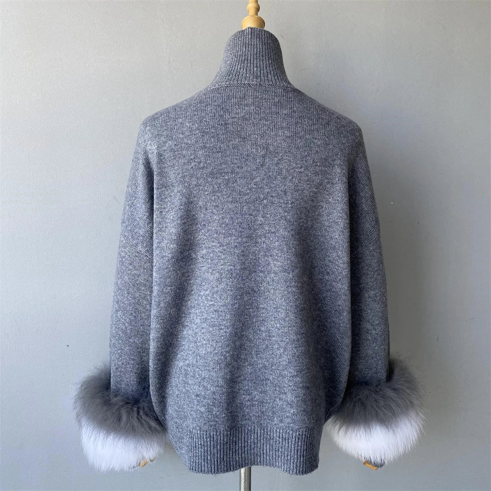 Gray sweater with white fur cuffs on a mannequin against a plain background