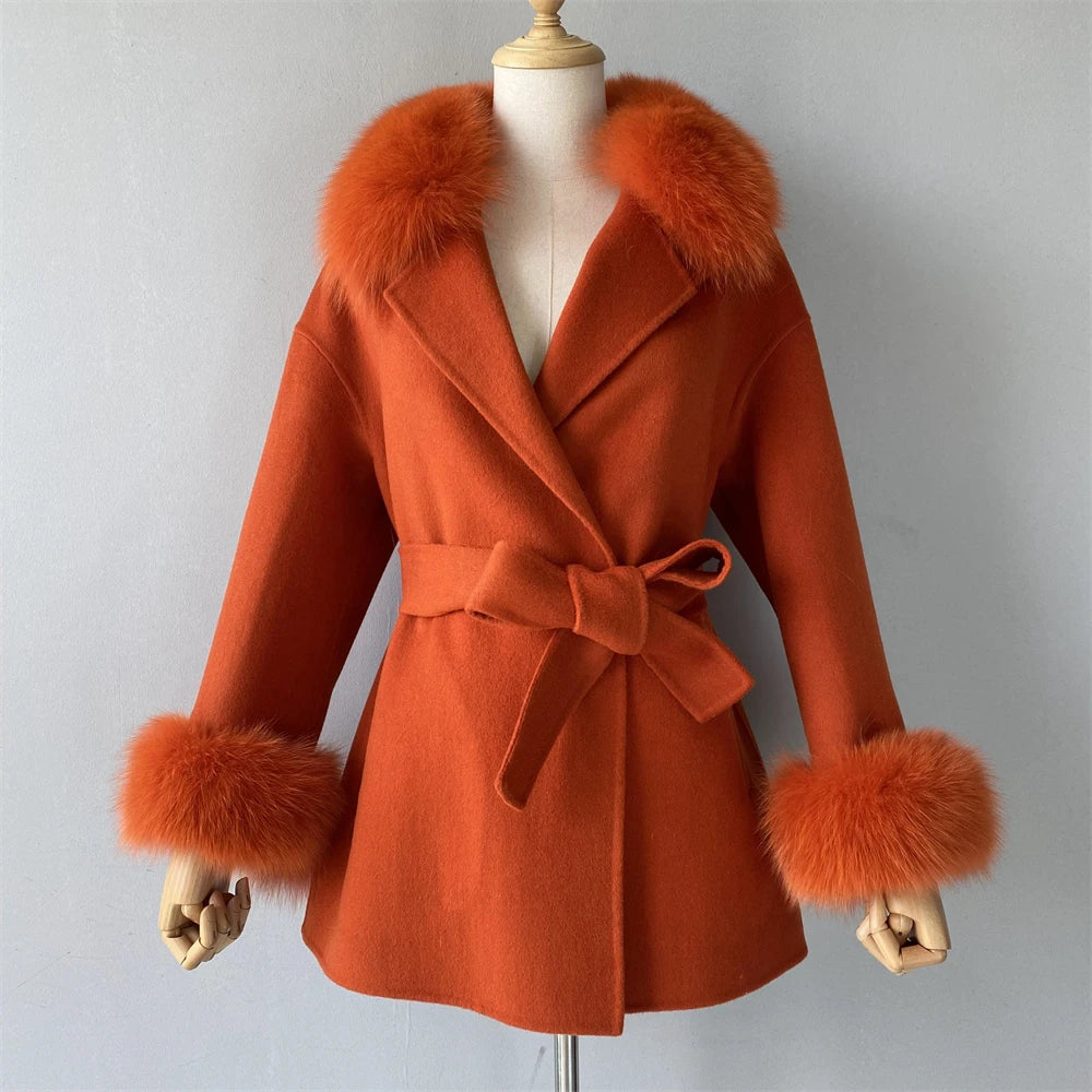Orange coat with fur trim on a mannequin against a gray background