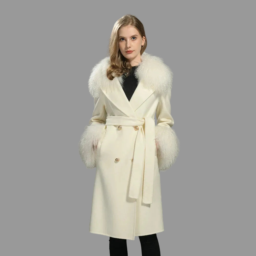 Woman wearing a cream coat with fur trim on a gray background