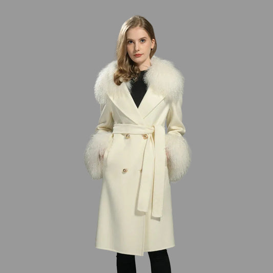 Woman wearing a cream coat with fur trim on a gray background