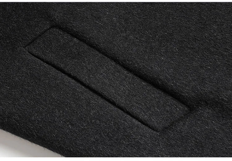Close-up of a black fabric with a pocket design, showing texture and color.