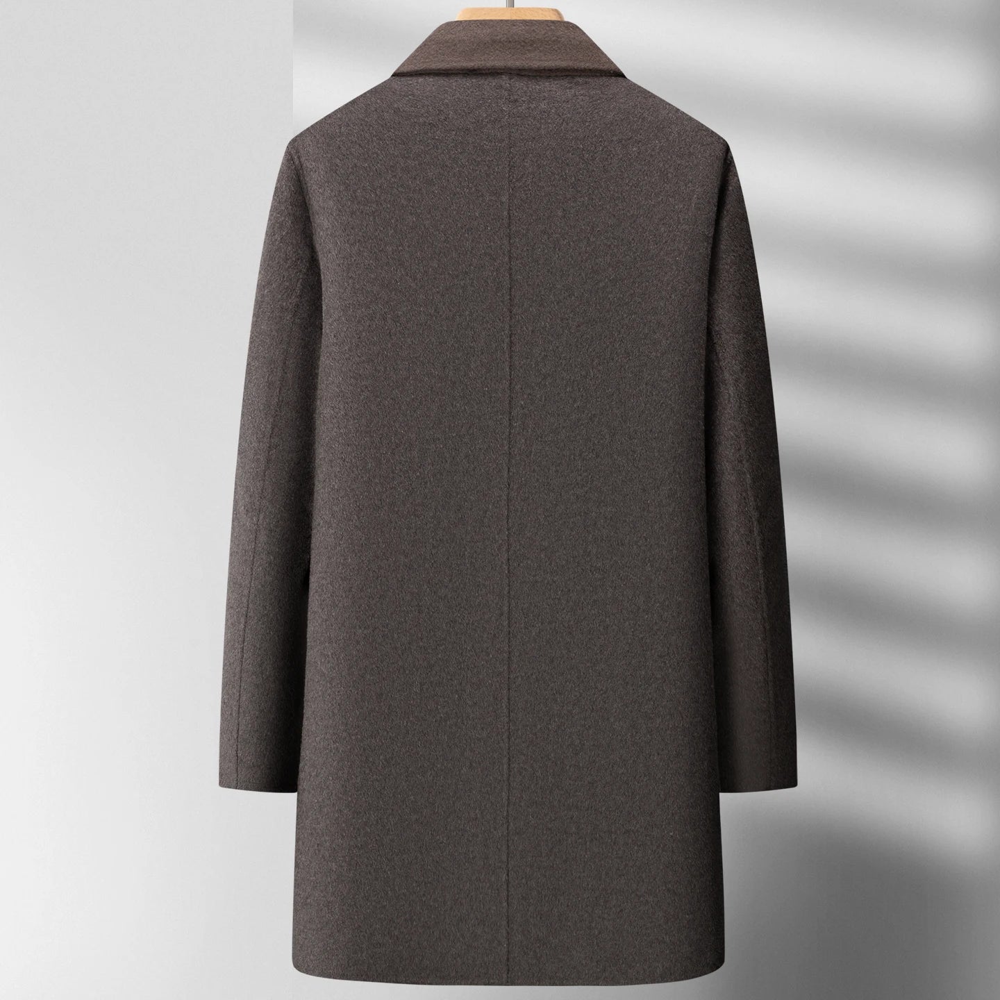 Gray coat on a mannequin against a white background