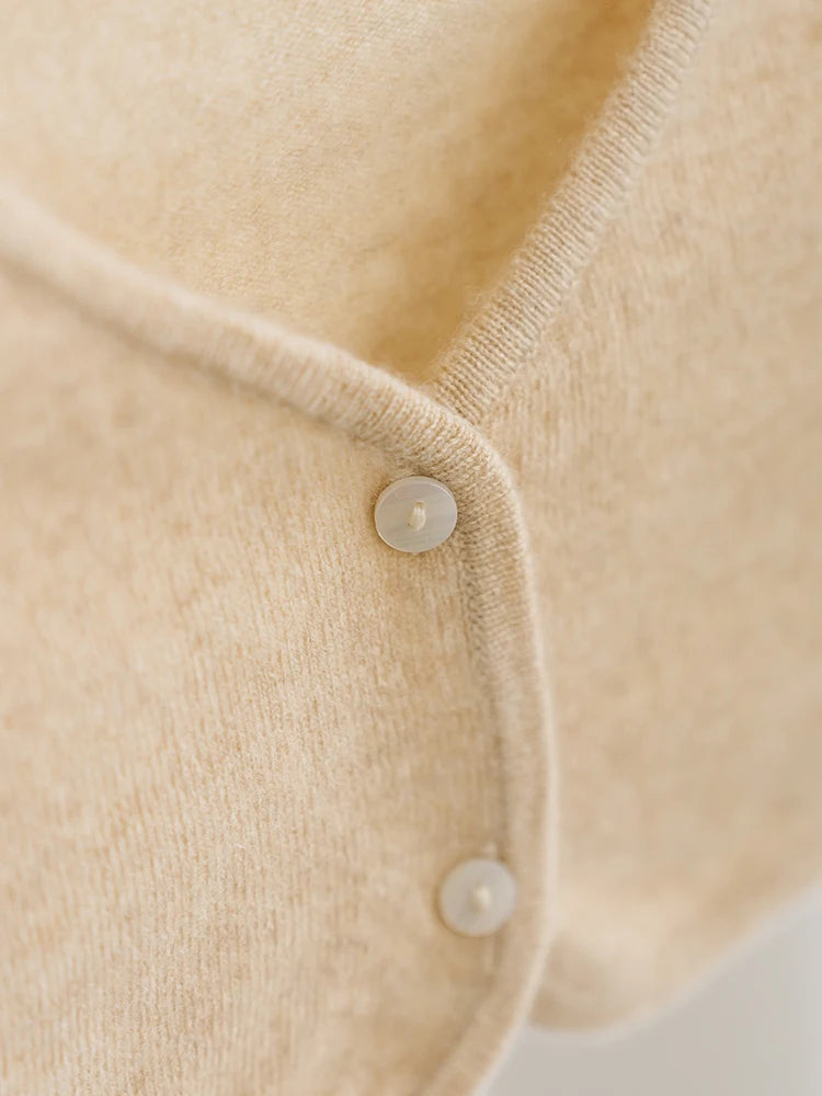 Close-up of a beige cardigan with button details