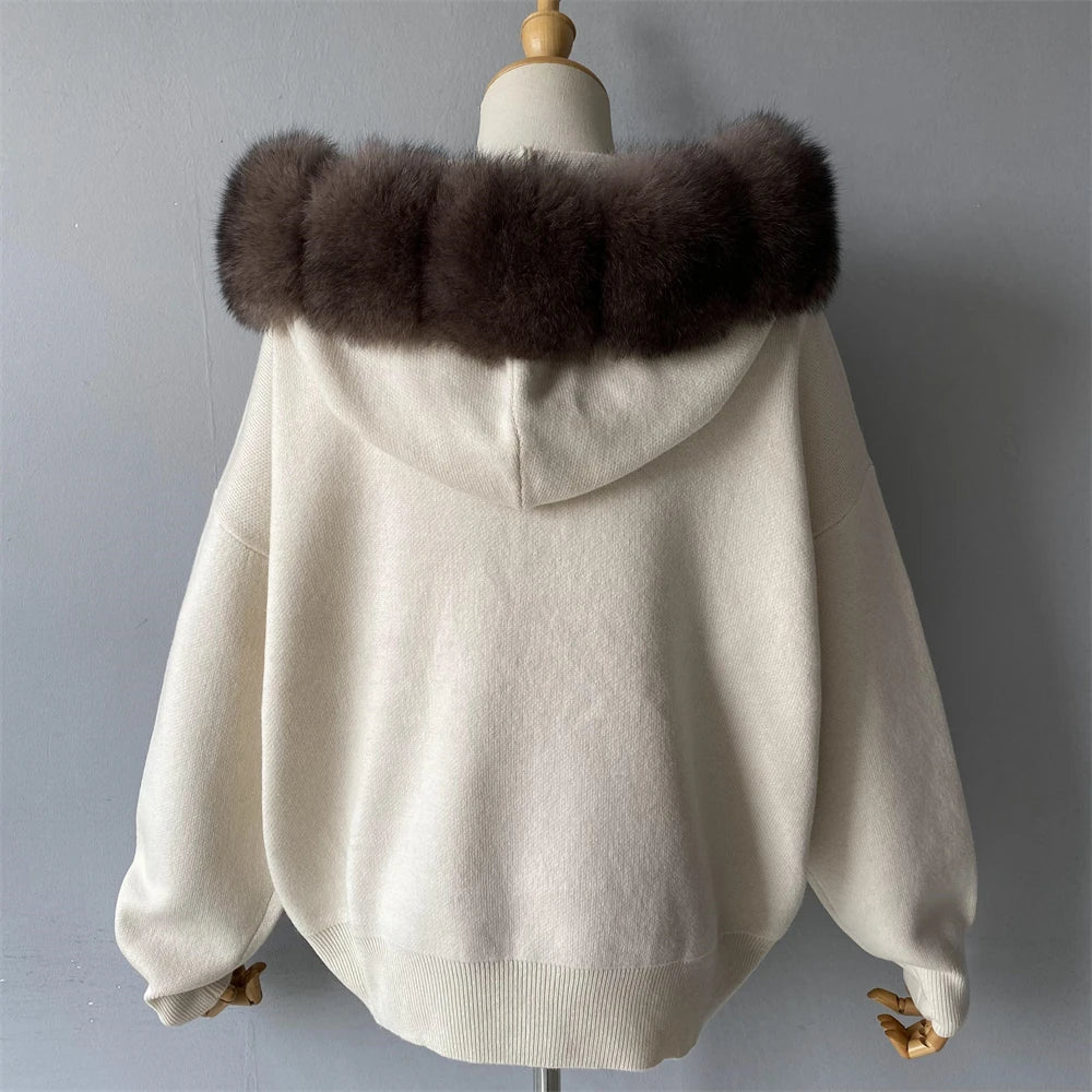 White sweater with brown fur collar on a mannequin against a gray background