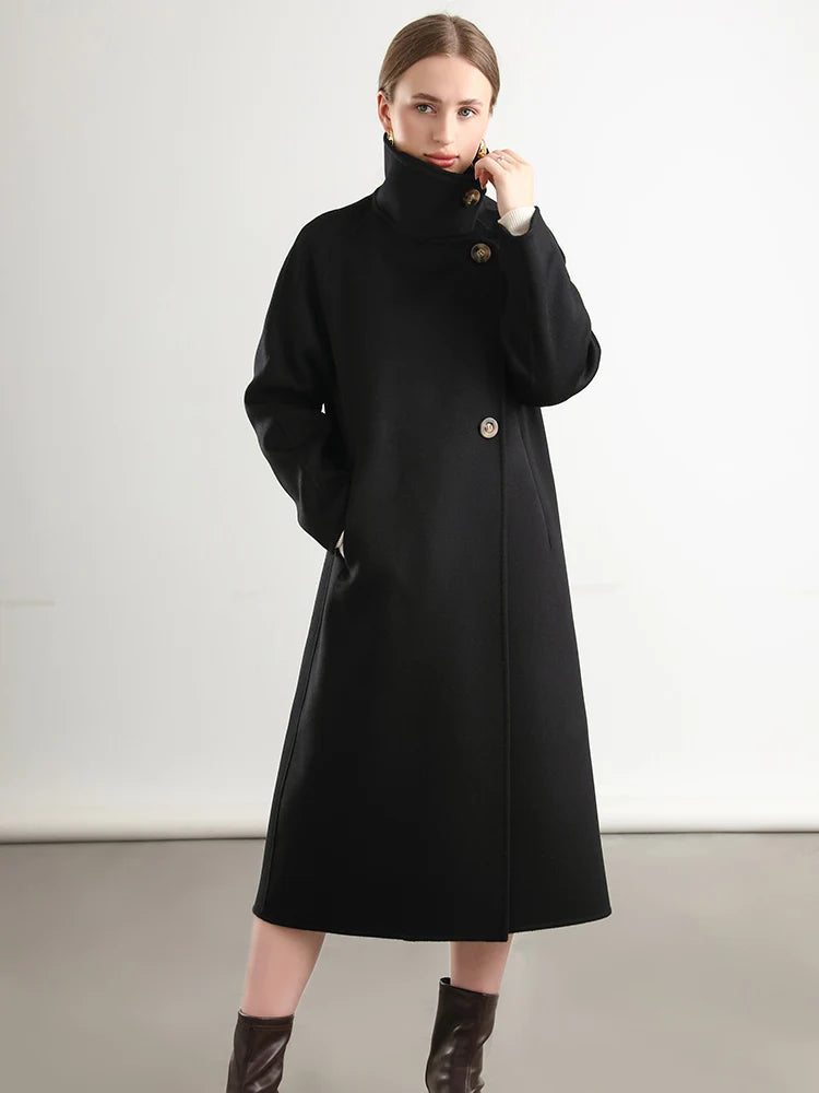 Woman wearing a black coat on a plain background