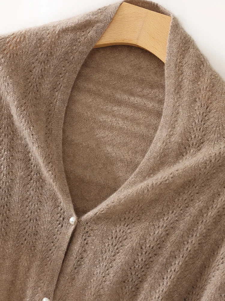 Brown knitted cardigan on a wooden hanger against a white background