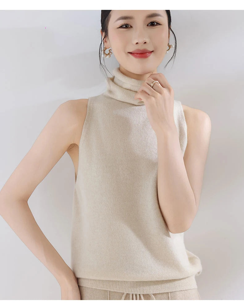 Woman wearing a beige sleeveless top against a plain background
