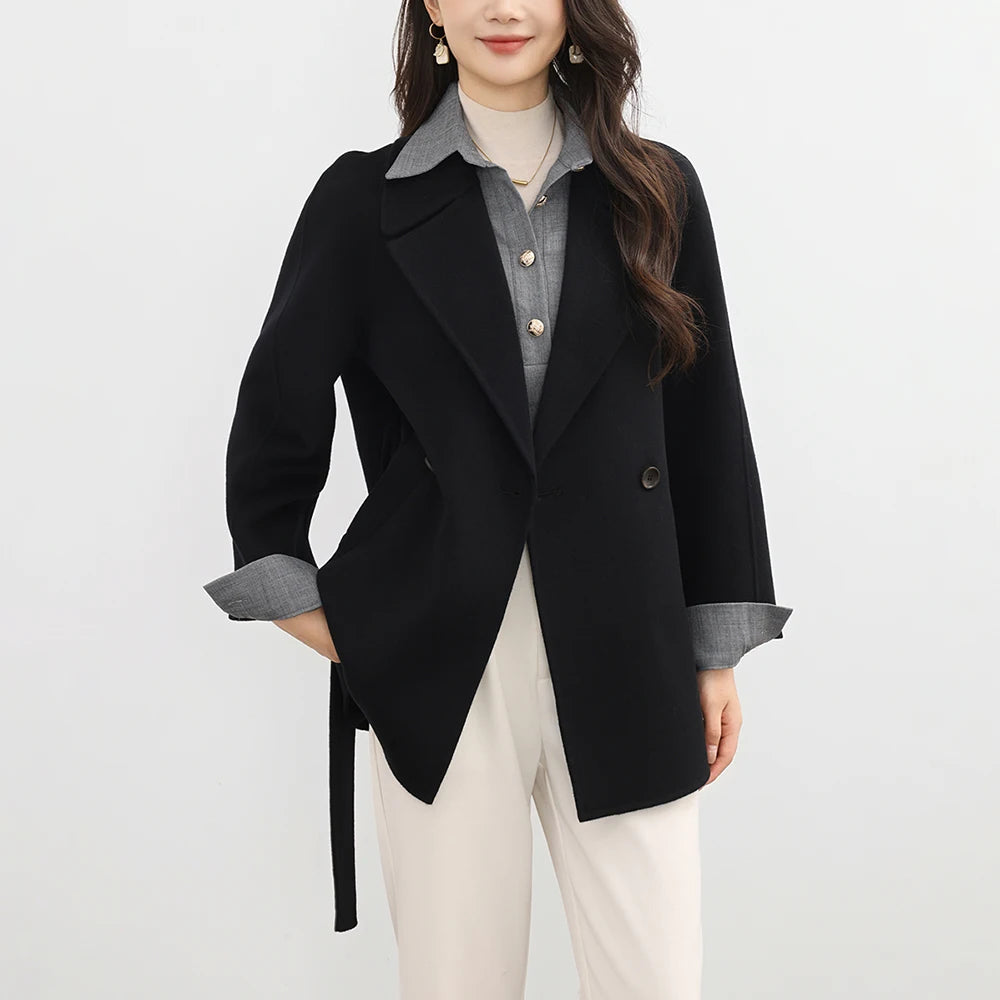 Person wearing a black coat with a white background
