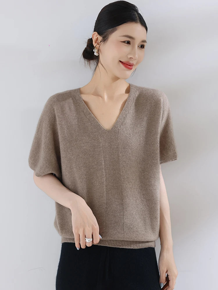Woman wearing a brown sweater against a white background