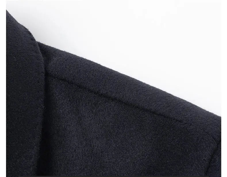 Close-up of a dark blue fabric with stitching details on a white background