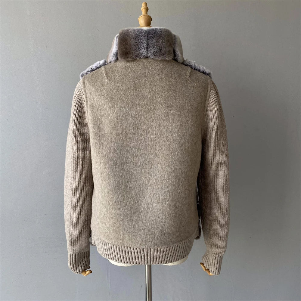 Beige sweater with fur collar on a mannequin against a gray background