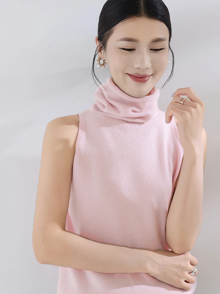 Woman wearing a pink sleeveless top against a plain background
