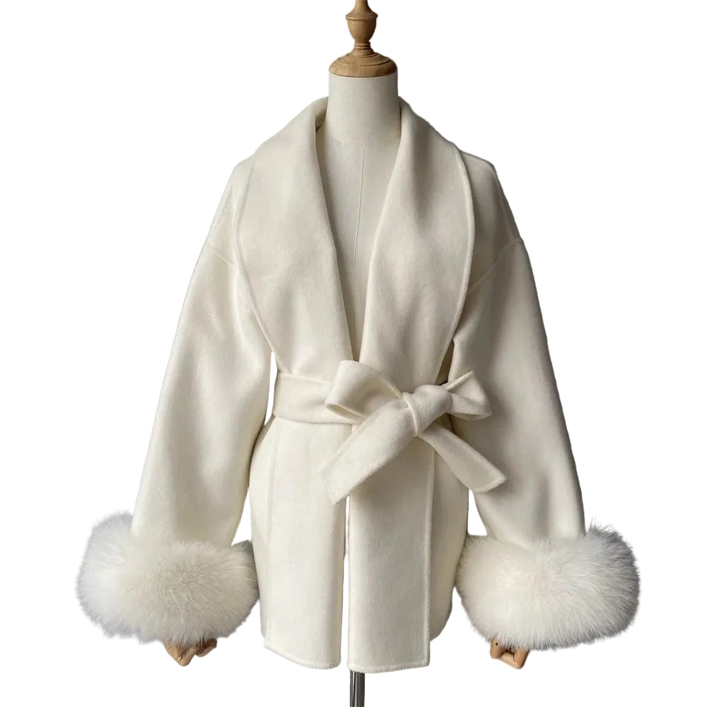 White coat with fur cuffs on a mannequin against a gray background