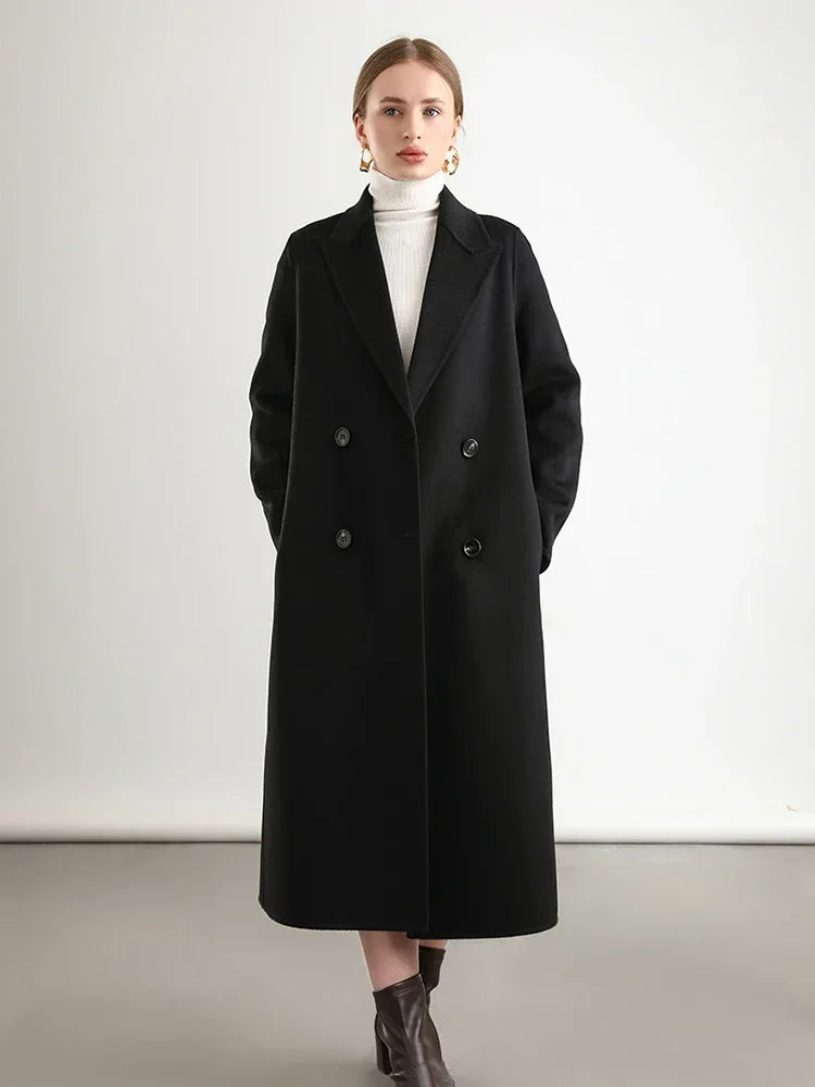 Woman wearing a black coat on a plain background