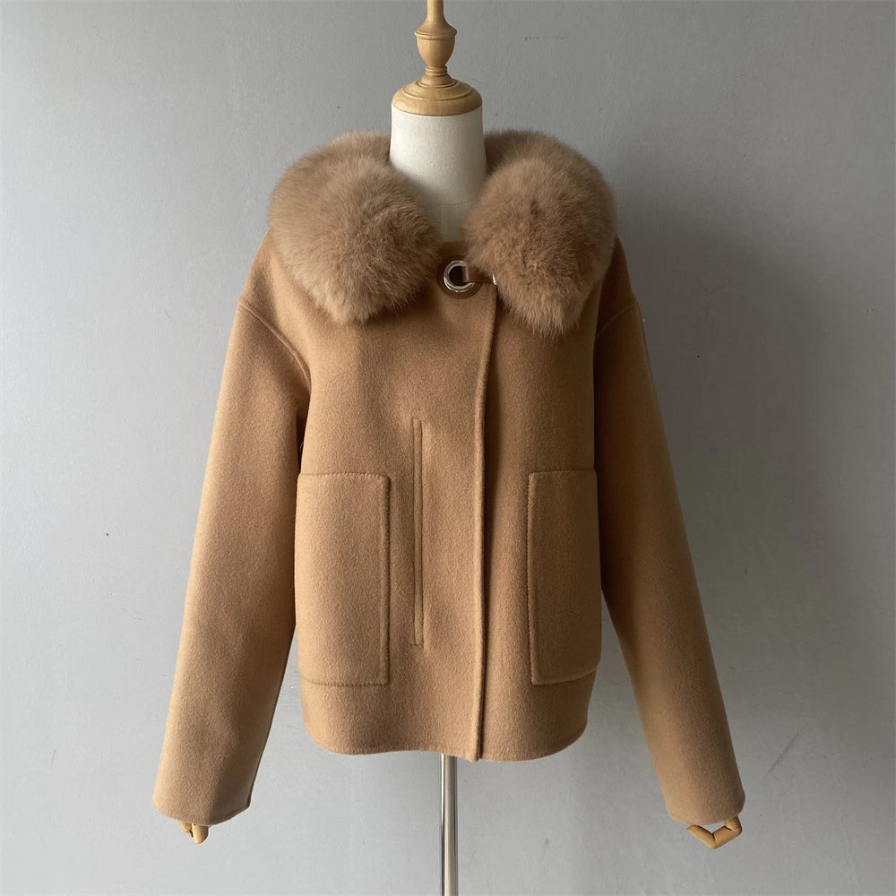 Brown coat with fur collar on a mannequin against a gray background