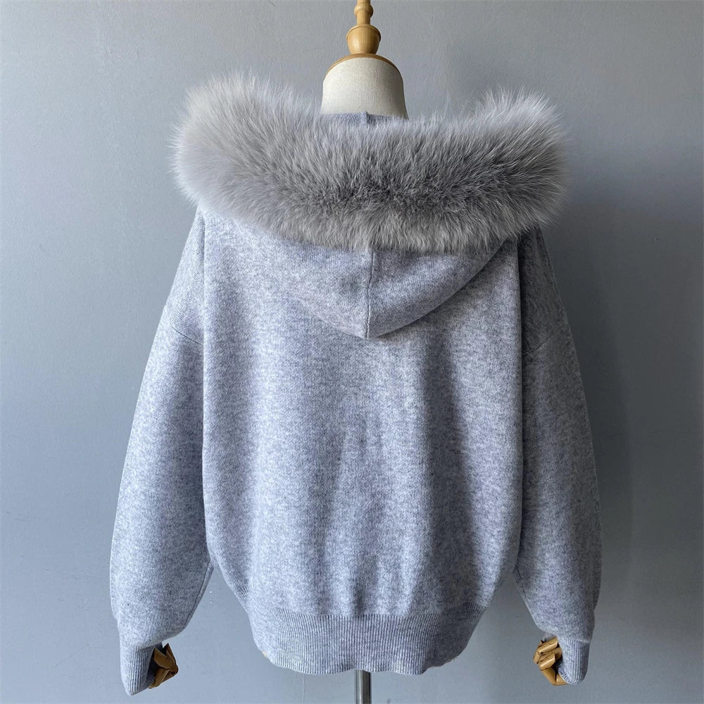 Gray hoodie with fur hood on a mannequin against a plain background