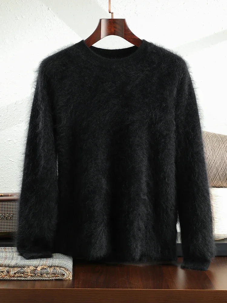 Black fuzzy sweater on a wooden hanger against a white wall.