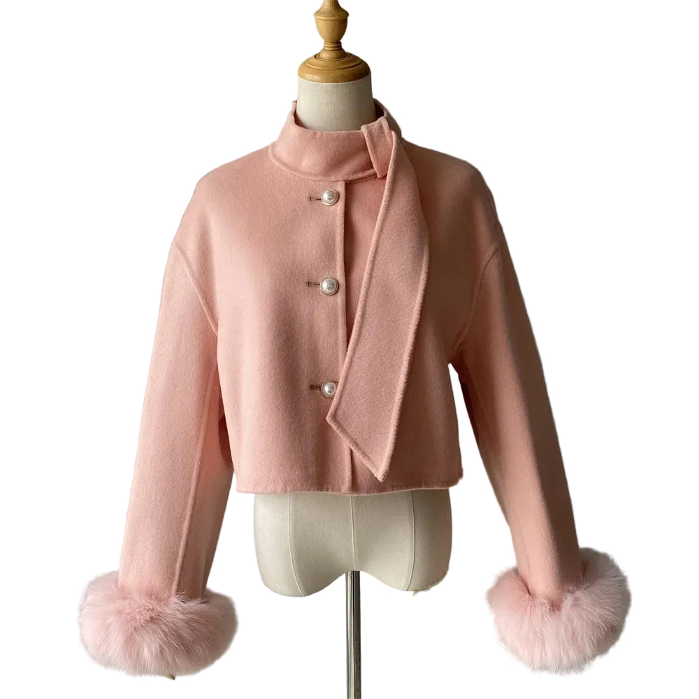 Pink jacket with fur cuffs on a mannequin against a gray background