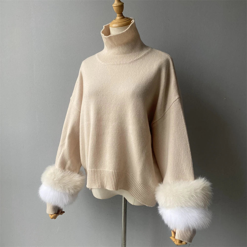 Beige sweater with fur cuffs on a mannequin against a gray background