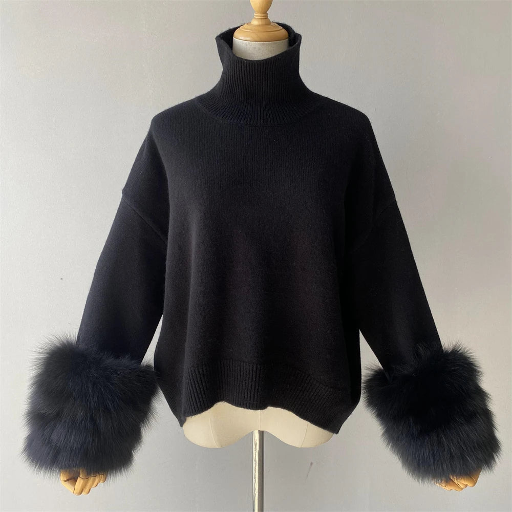 Black sweater with fur cuffs on a mannequin against a plain background