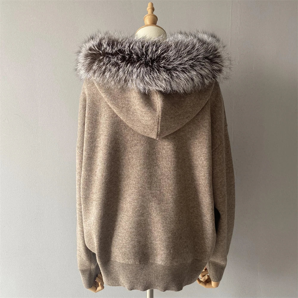 Beige hoodie with fur hood on a mannequin against a neutral background