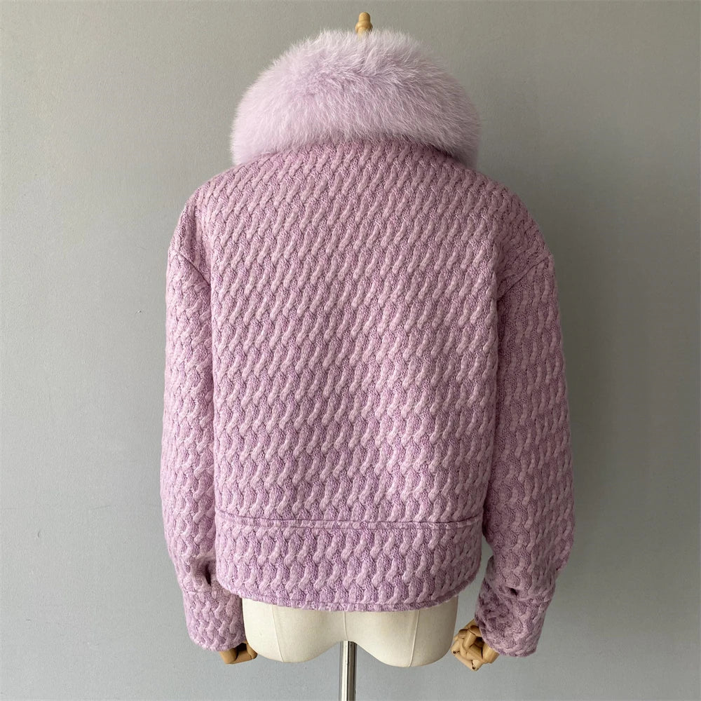 Pink textured jacket with fur hood on a mannequin against a plain background