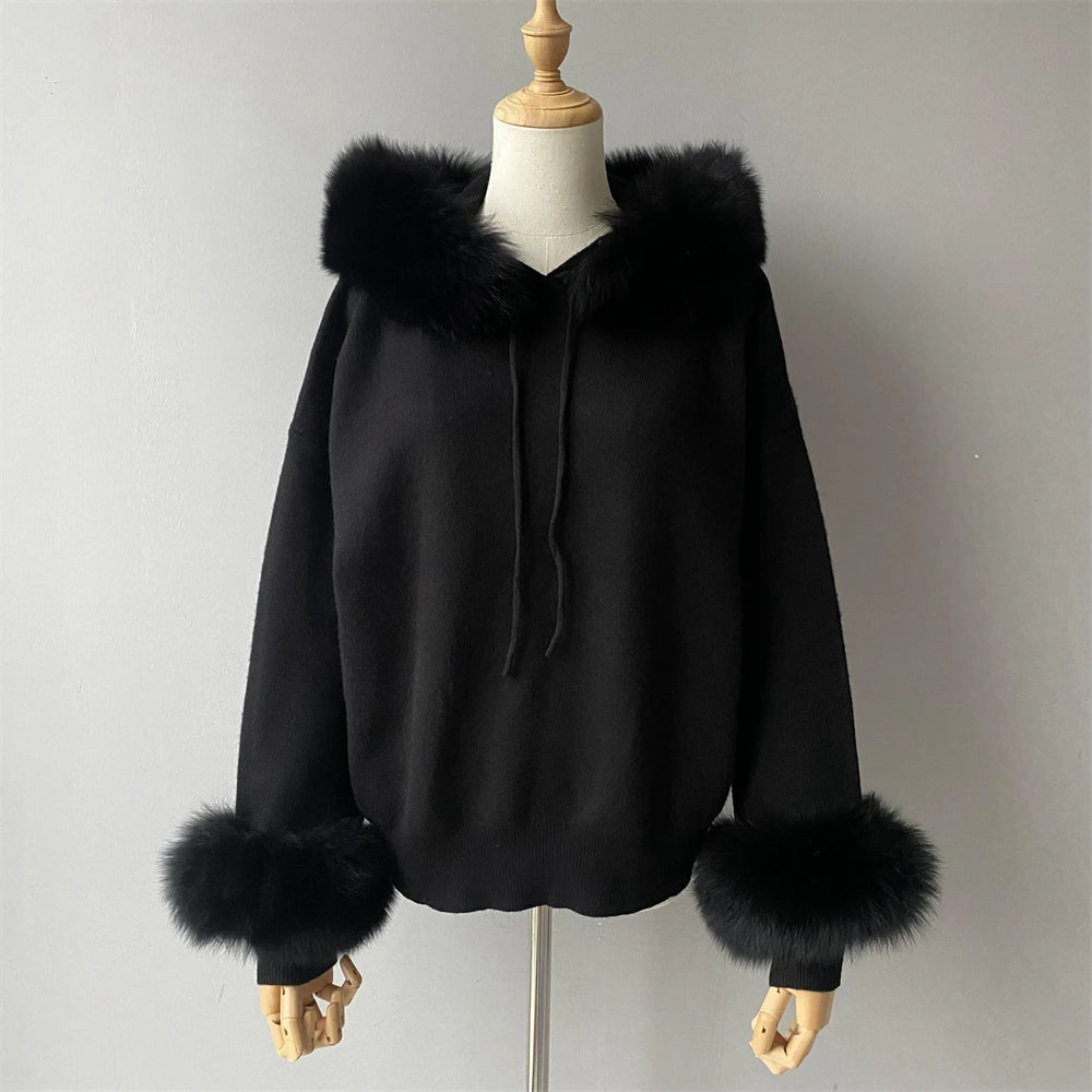 Black hoodie with fur trim on a mannequin against a plain background