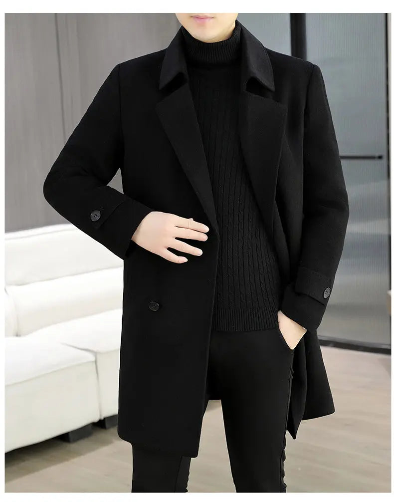 Person wearing a black coat and sweater in an indoor setting