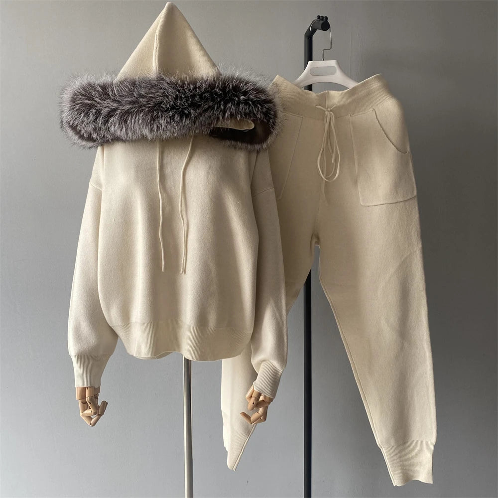 Beige hoodie with fur hood and matching pants on a gray background
