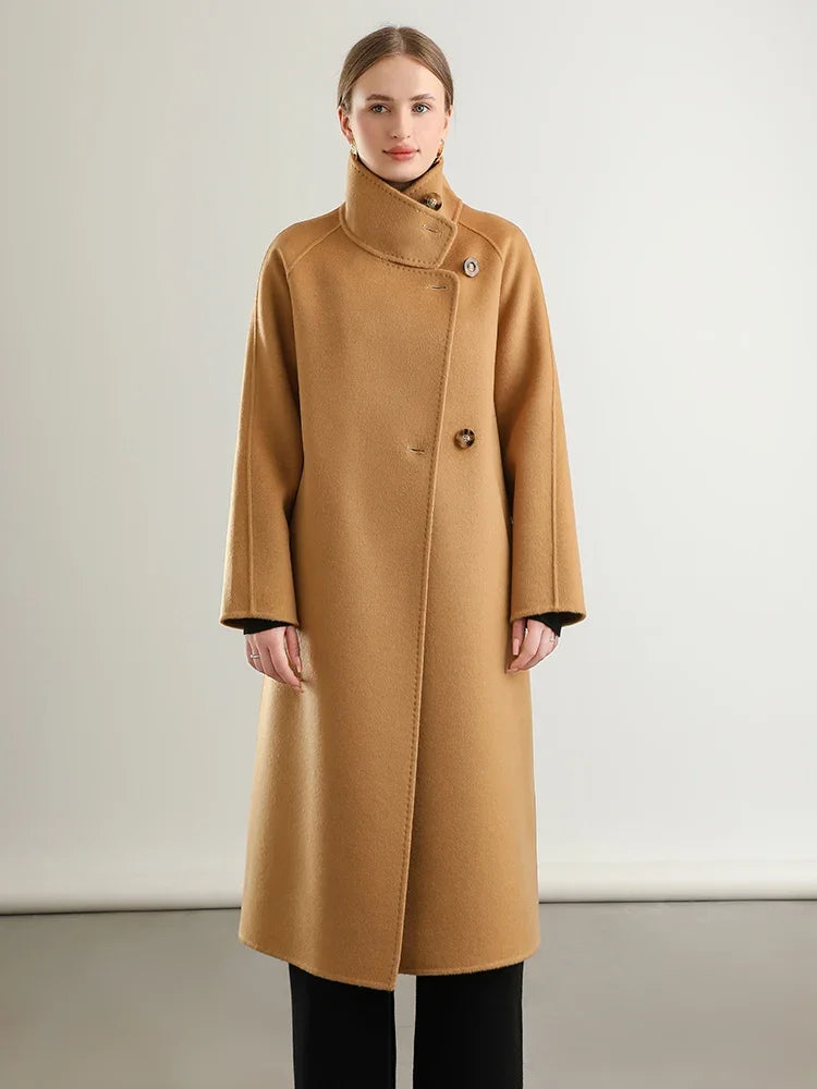 Woman wearing a brown coat against a plain background
