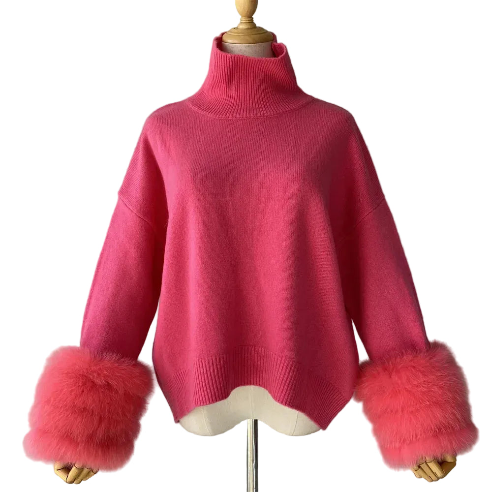 Pink sweater with fur cuffs on a mannequin against a gray background