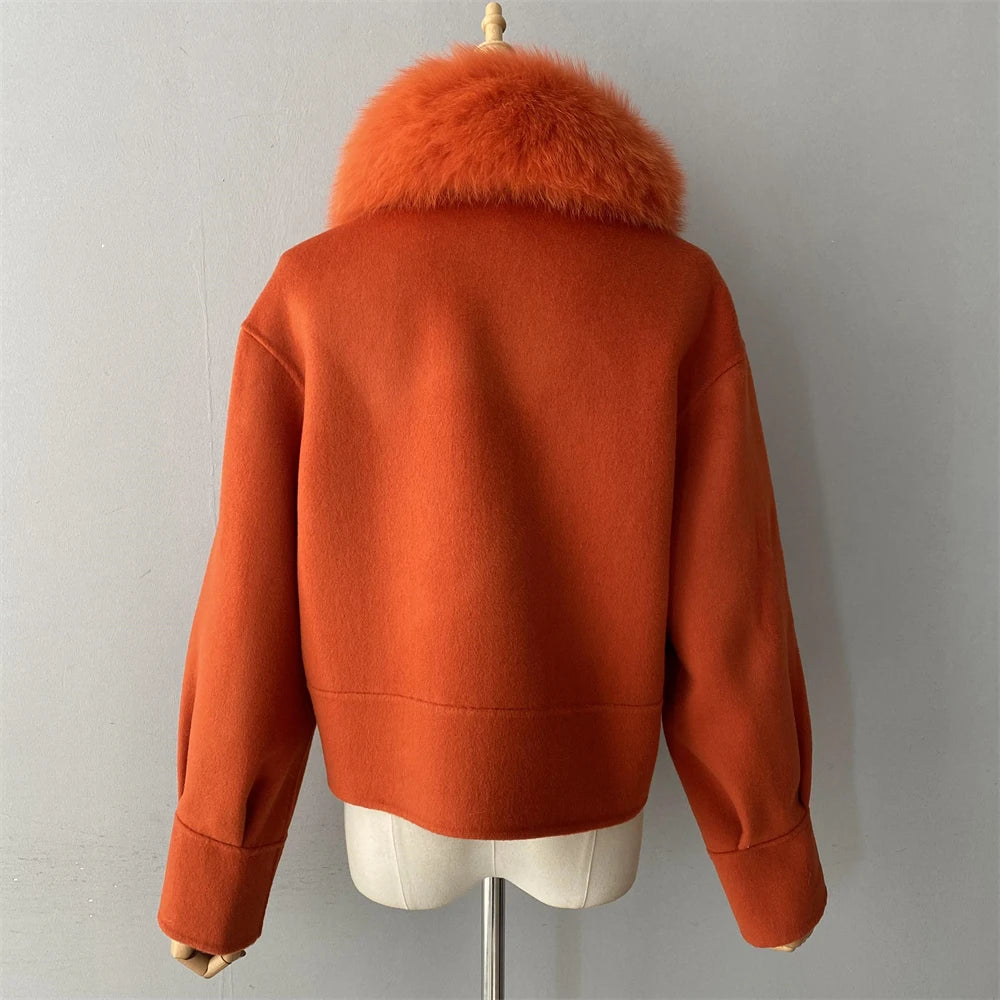 Orange jacket with fur collar on a mannequin against a gray background