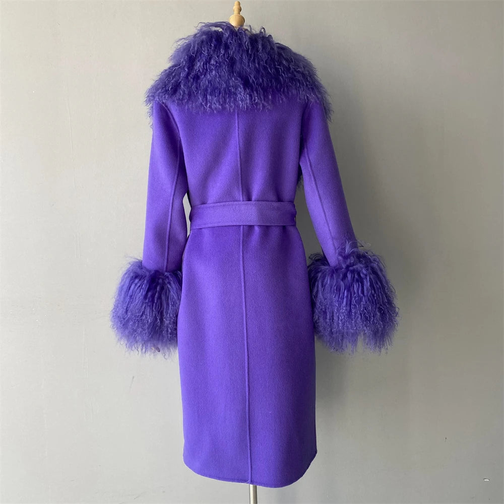 Purple coat with feathered cuffs and collar on a mannequin against a plain background