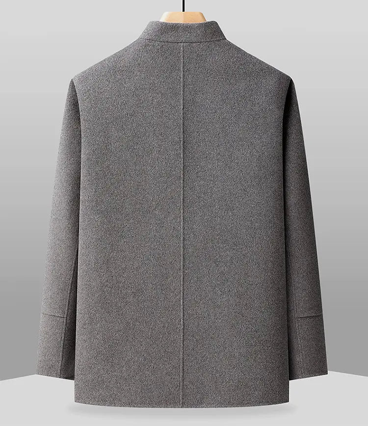 Gray coat on a mannequin against a gray background
