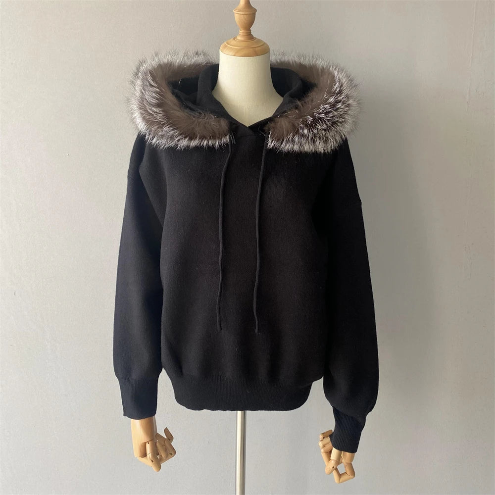 Black hoodie with fur-lined hood on a mannequin against a plain background