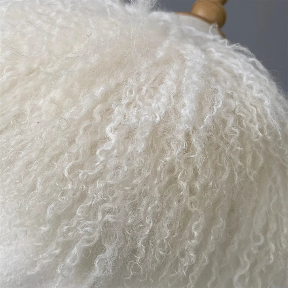 Close-up of a white, curly sheepskin rug on a wooden stand.