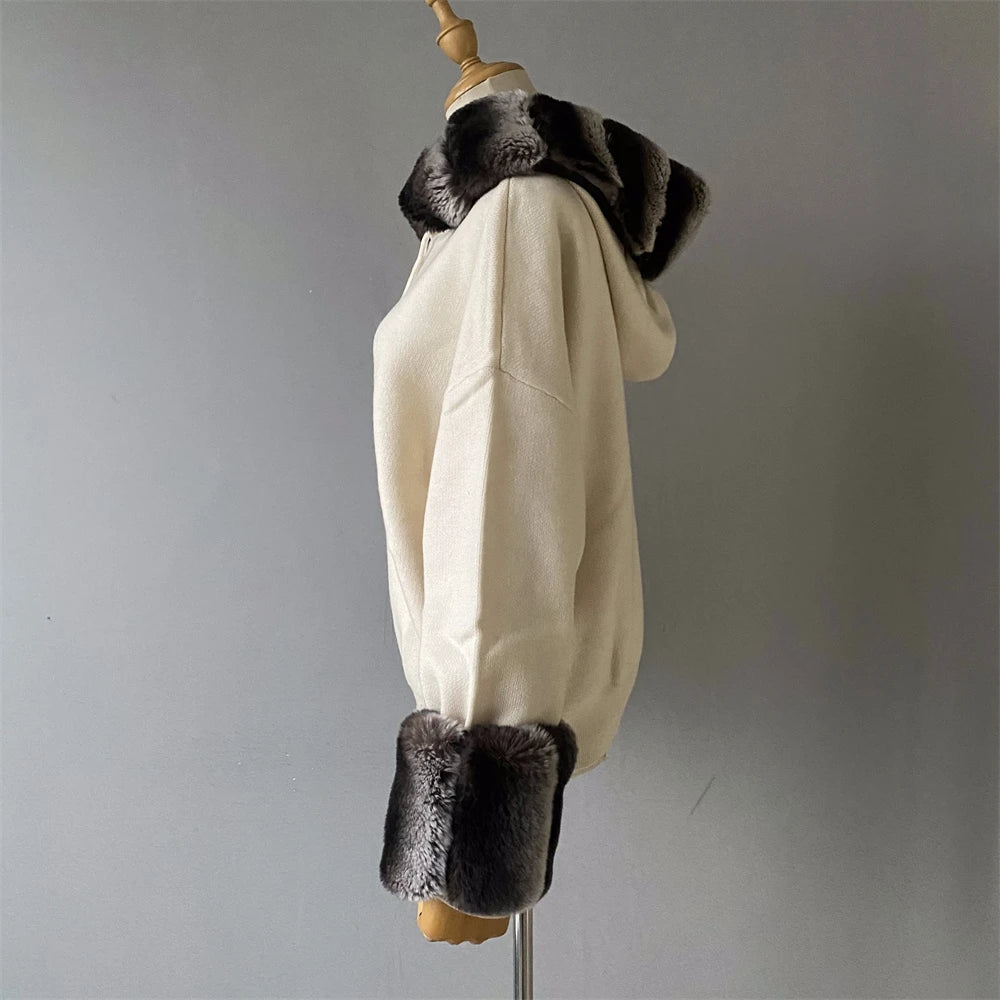 White coat with black fur trim on a mannequin against a gray background