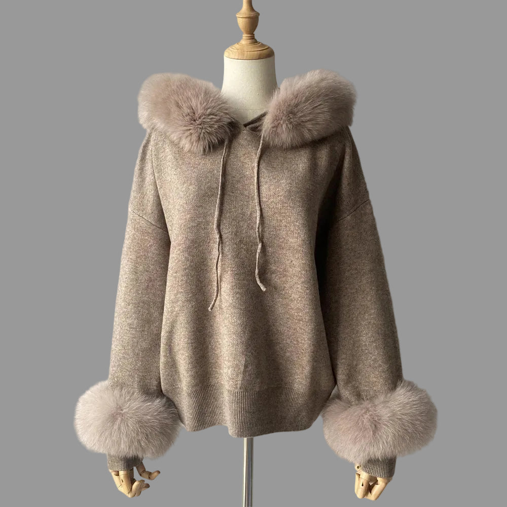Beige hooded coat with fur trim on a mannequin against a plain background
