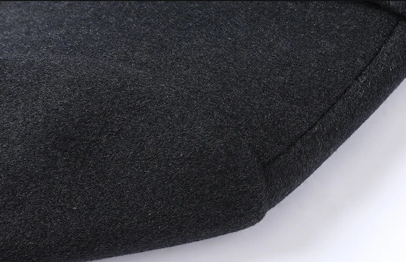 Close-up of a dark gray fabric shoulder on a white background