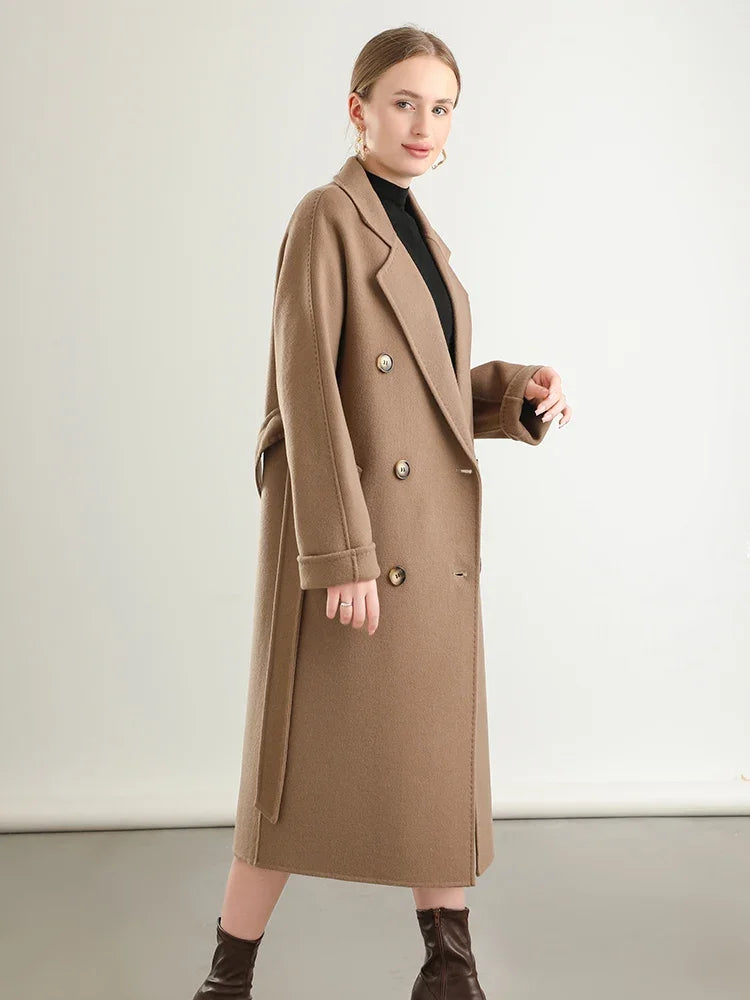 Woman wearing a long beige coat on a white background